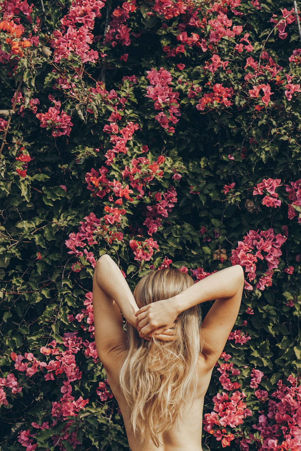 a woman lying in a bush