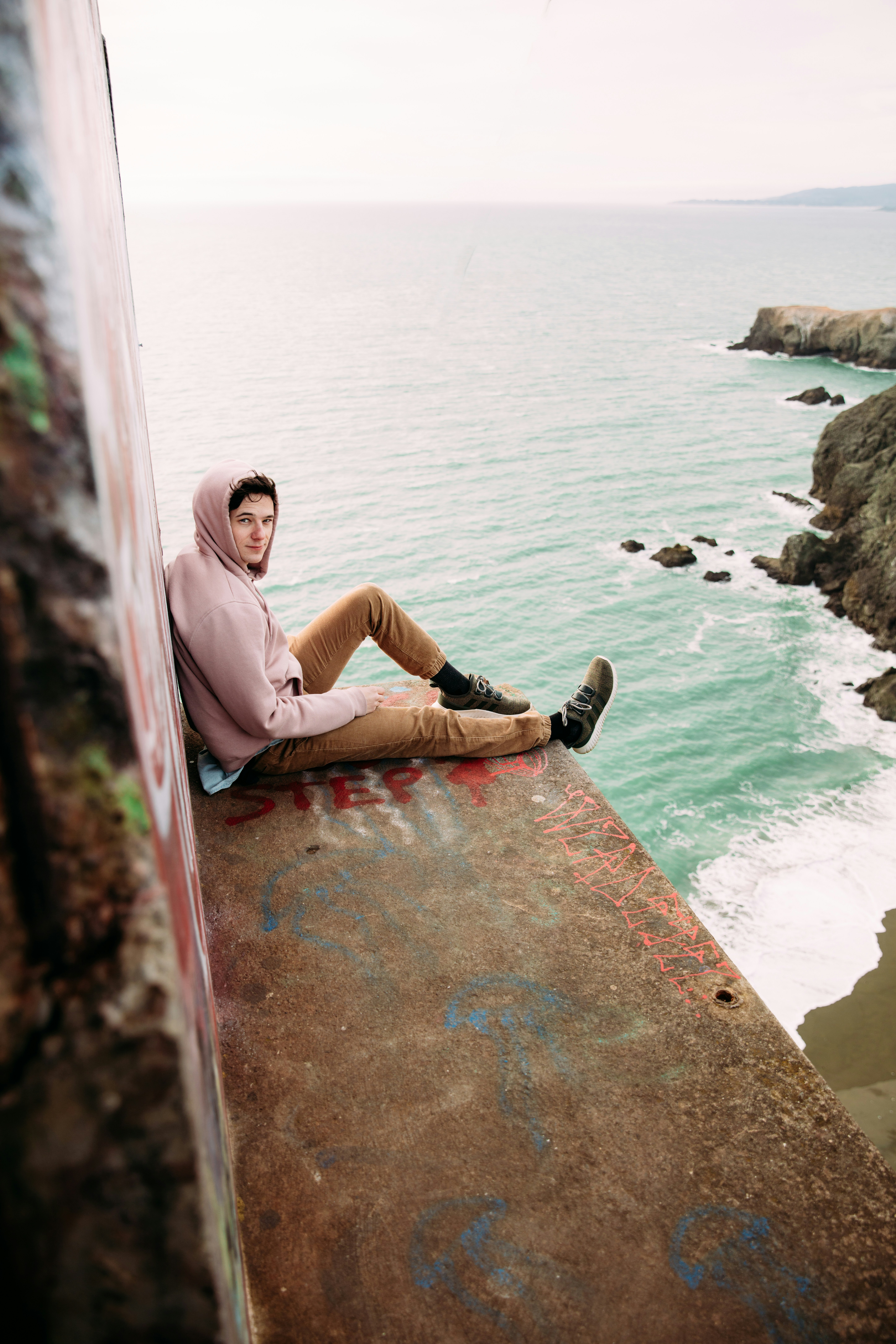 a person sitting on a rock ledge