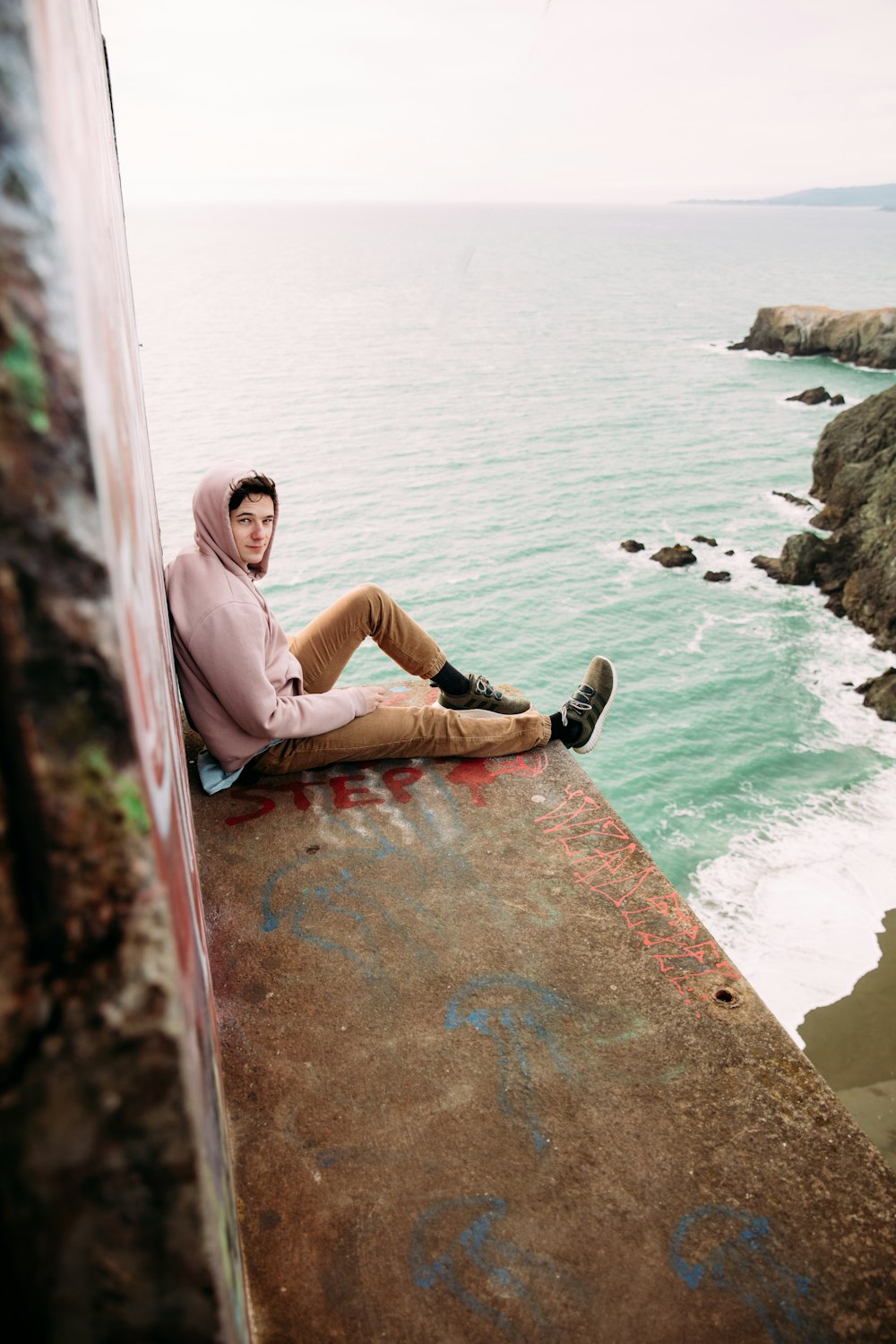 a person sitting on a rock ledge