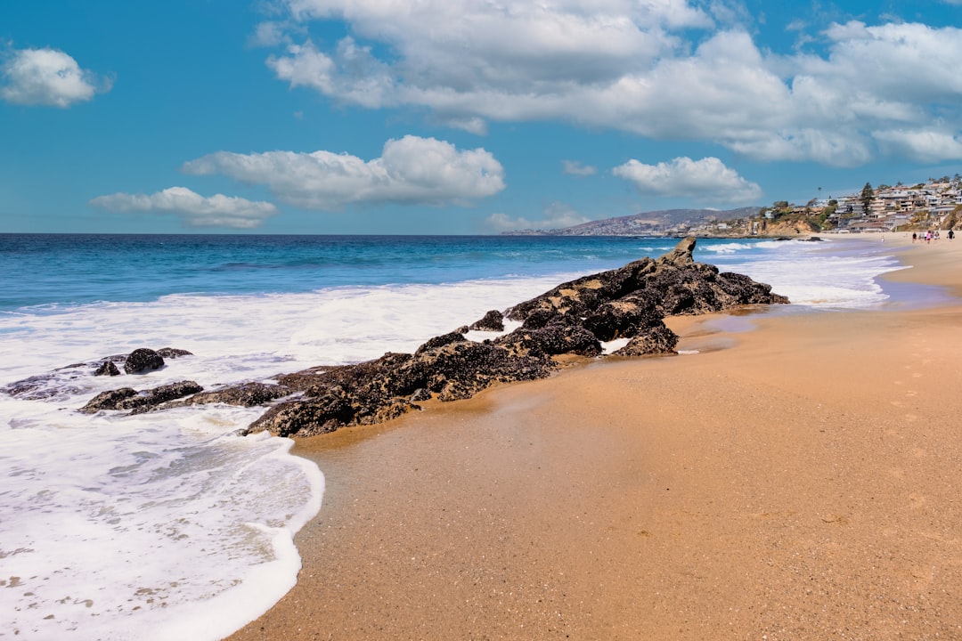 a beach with rocks and water,