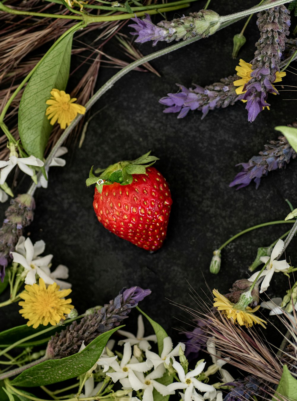 a strawberry on the ground