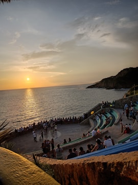Sunset view of a beach sprint race with cheering spectators.