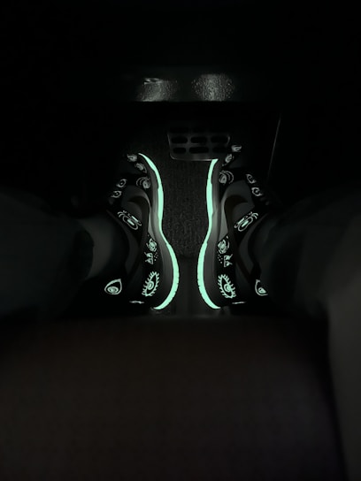 Close-up of a sleek, futuristic sneaker with glowing accents on a dark, dynamic background.