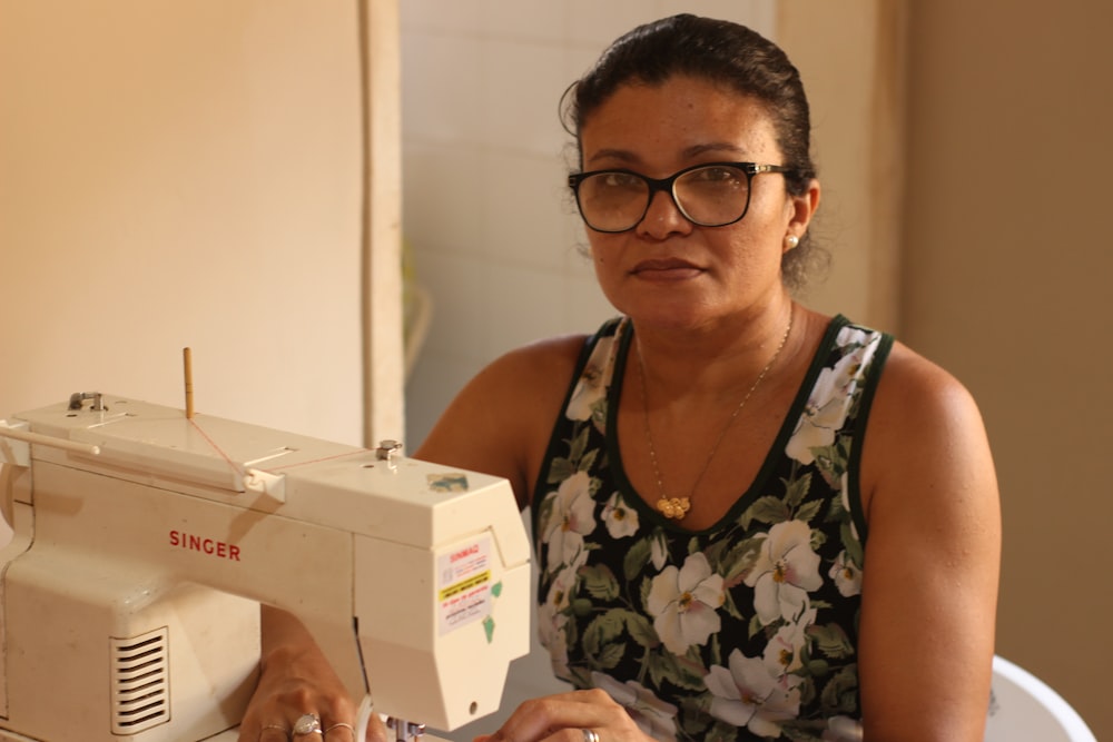 a person holding a sewing machine