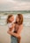 a person holding a child on a beach