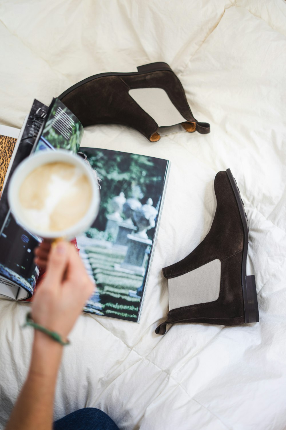 a person holding a picture of a tree and a cup of coffee