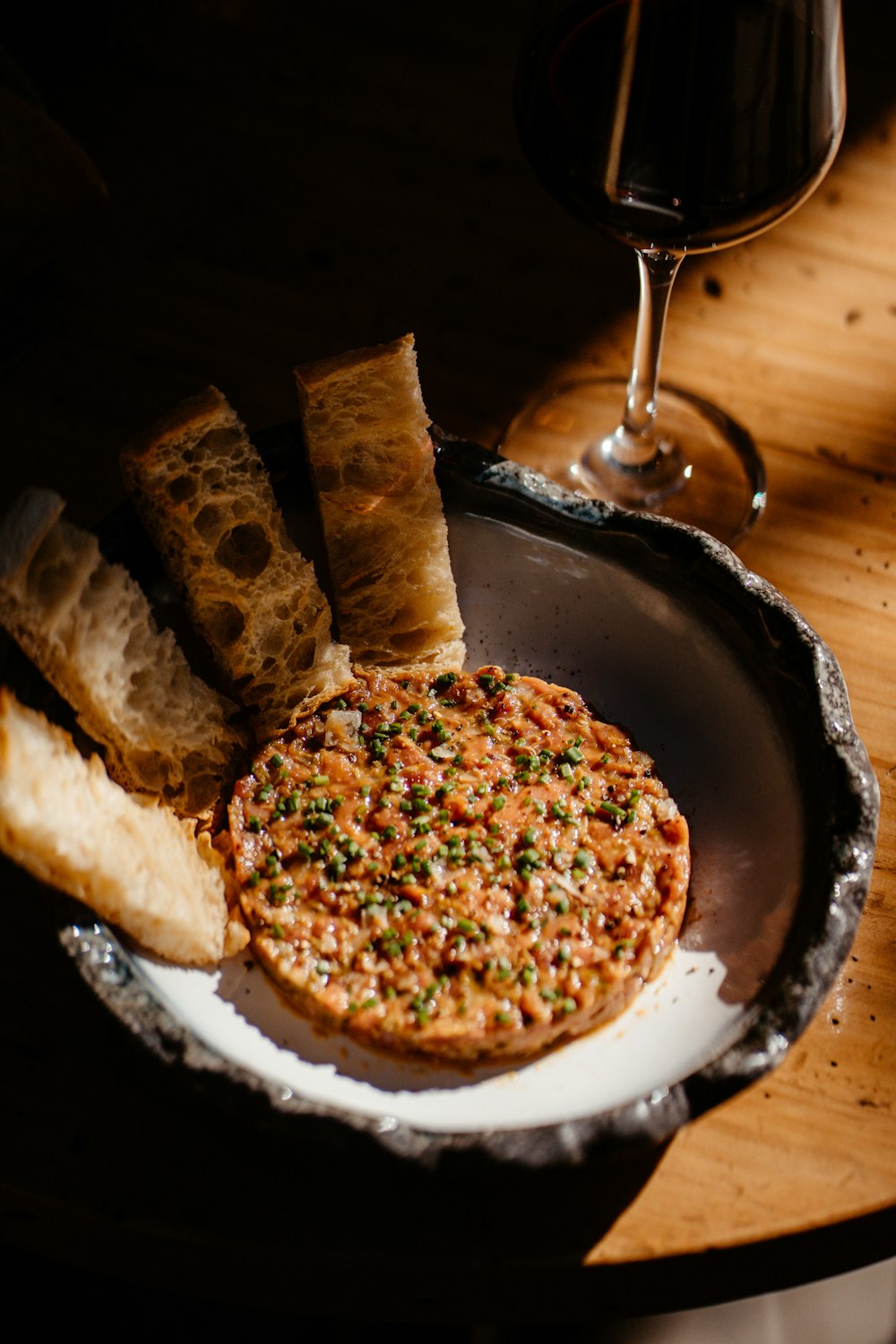 a plate of food and a glass of wine