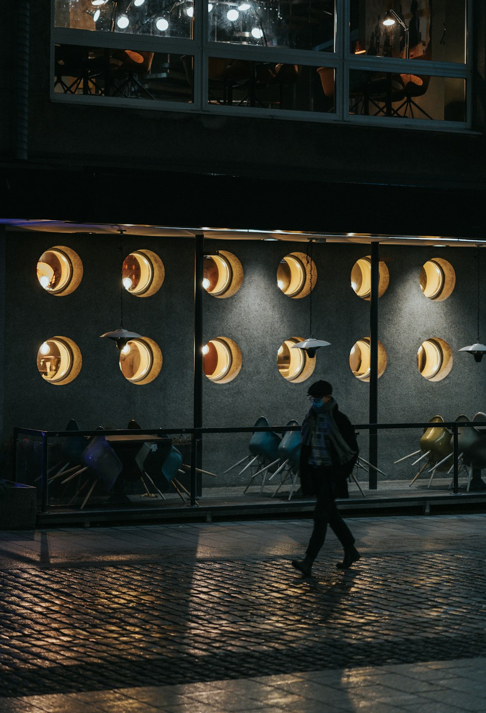 a person walking past a large metal object