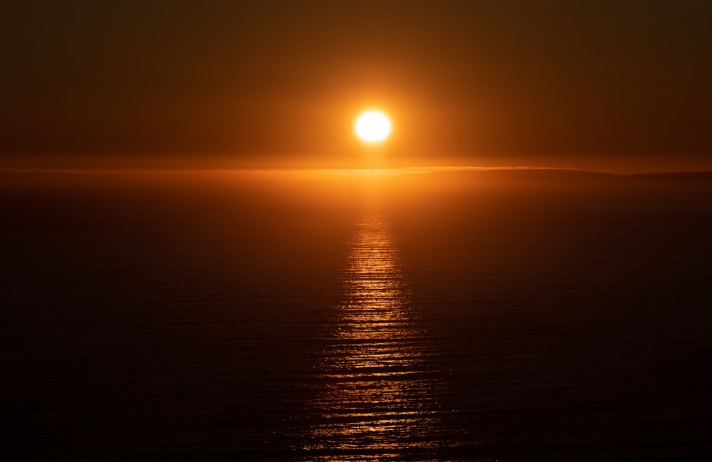 a sunset over a body of water