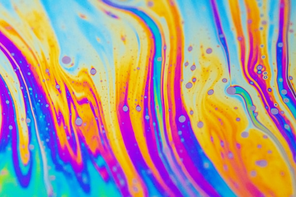 A colorful display of psychedelic folk art featuring bold lime green, purple, orange, and pink hues.