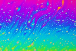 Colorful geometric patterns blending with images of stars and galaxies.