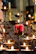 Softly glowing candle centerpiece on a table set for a communion celebration.