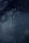 Droplets of water are suspended in mid-air against a dark background, with a focus on their glistening surfaces. The drops appear as if captured in motion, emphasizing their clarity and the subtle play of light.
