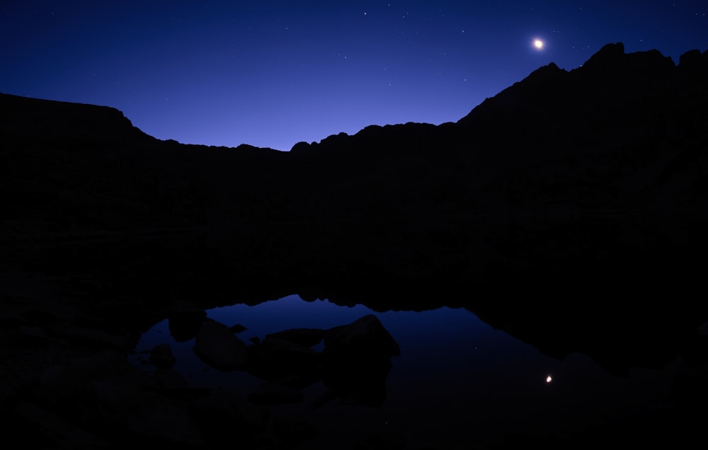 a mountain with the moon in the background