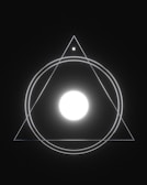 A geometric design features a large glowing white circle at the center, enclosed within concentric circles and an equilateral triangle. A smaller circle is situated at the top vertex of the triangle. The design is set against a dark background, creating a minimalist yet striking visual.