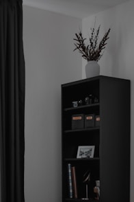 a vase with flowers on a shelf