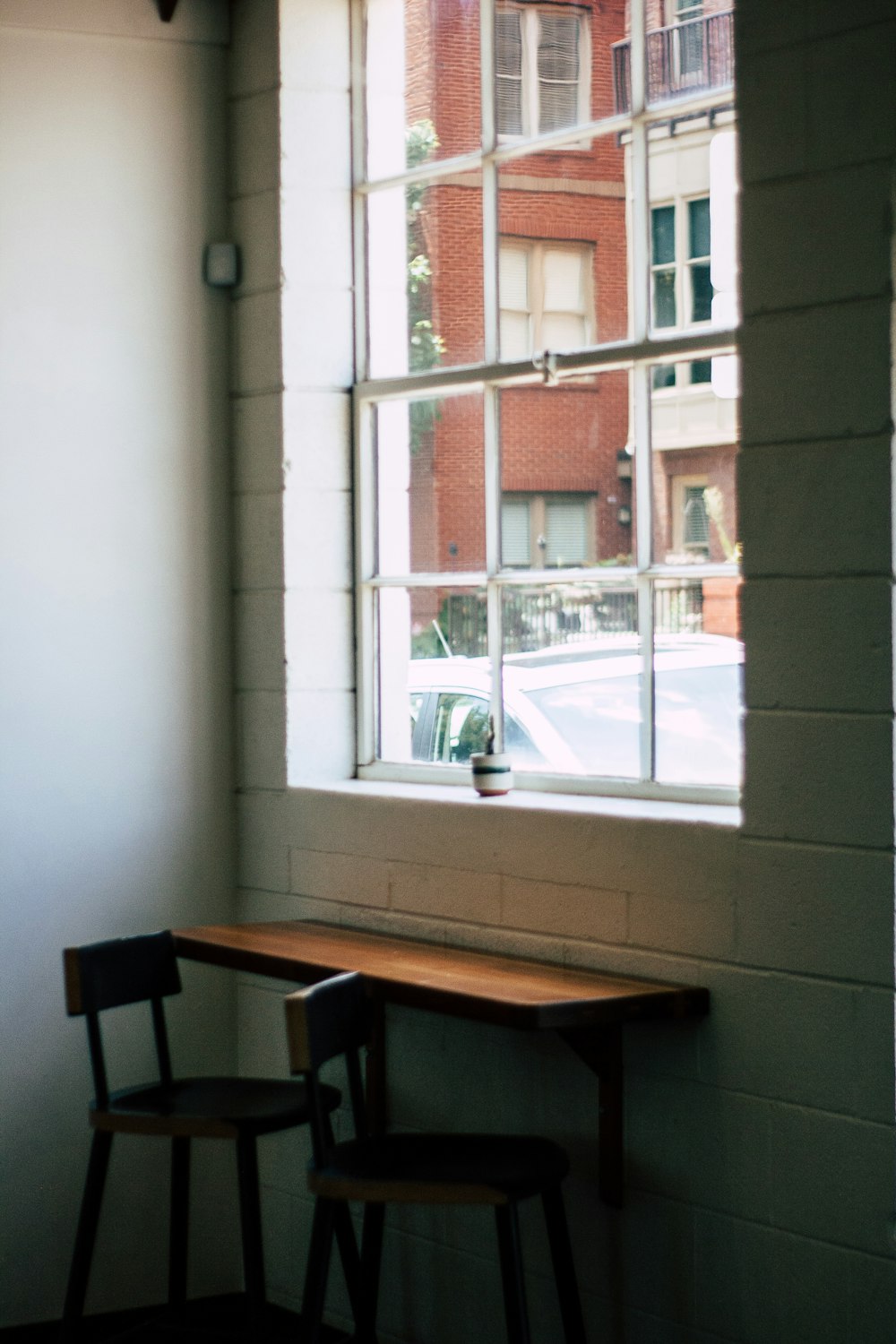 a table and chairs in a window