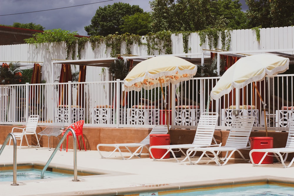 a pool with chairs and umbrellas