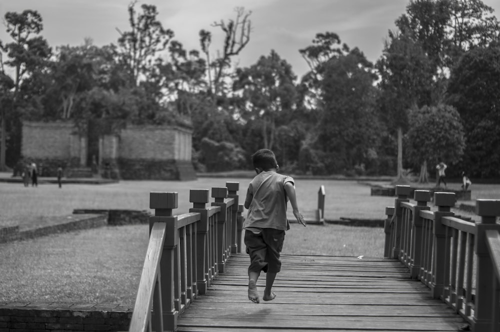 a person walking on a wooden bridge