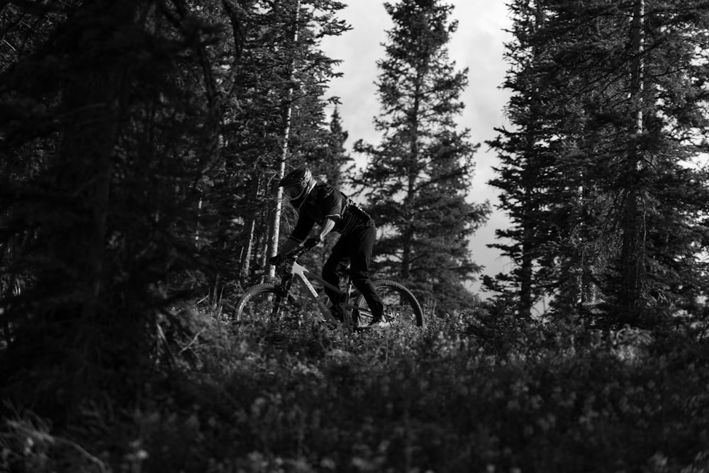 a person riding a bike through the woods