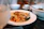 Close-up of a colorful Asian fusion dish with chopsticks resting beside the plate.