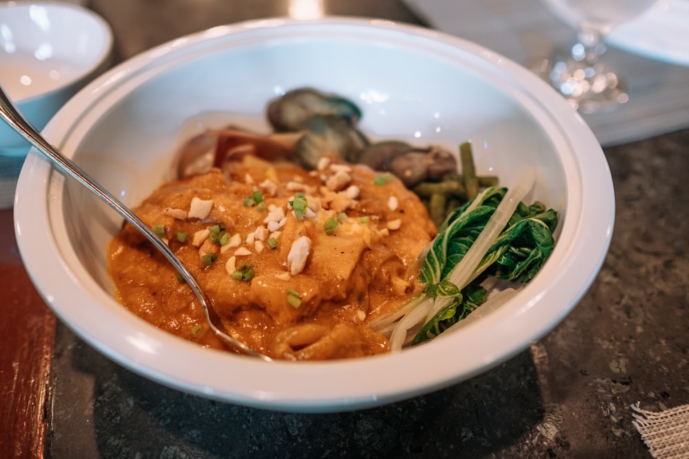 a bowl of soup with a spoon