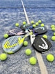 tennis rackets and balls on a tennis court