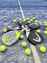 tennis rackets and balls on a tennis court