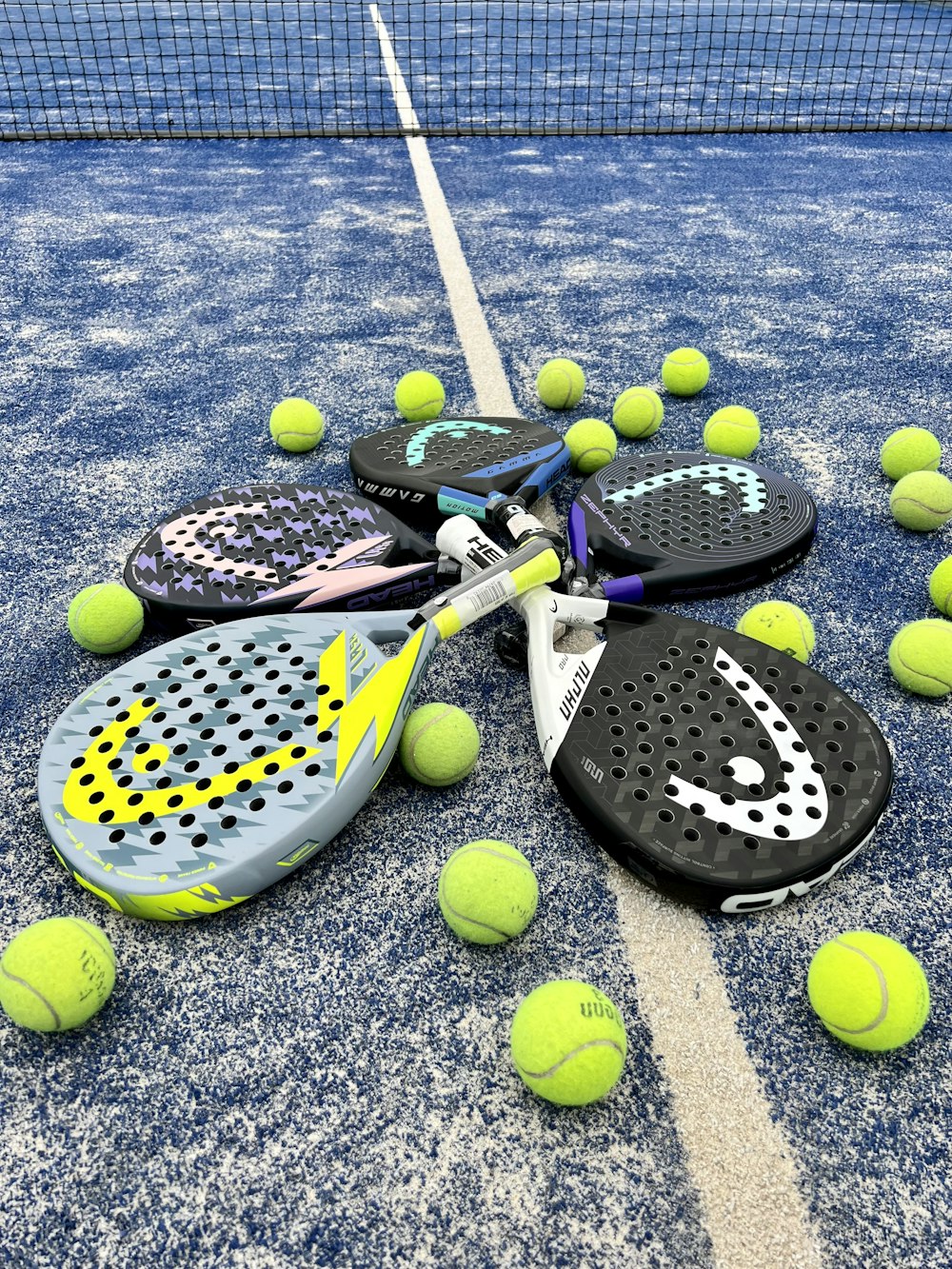 tennis rackets and balls on a tennis court