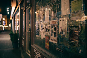 Outdoor shot of a small business storefront proudly displaying promotional posters