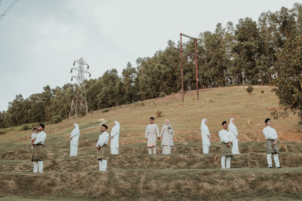 a group of people in white robes standing in a field