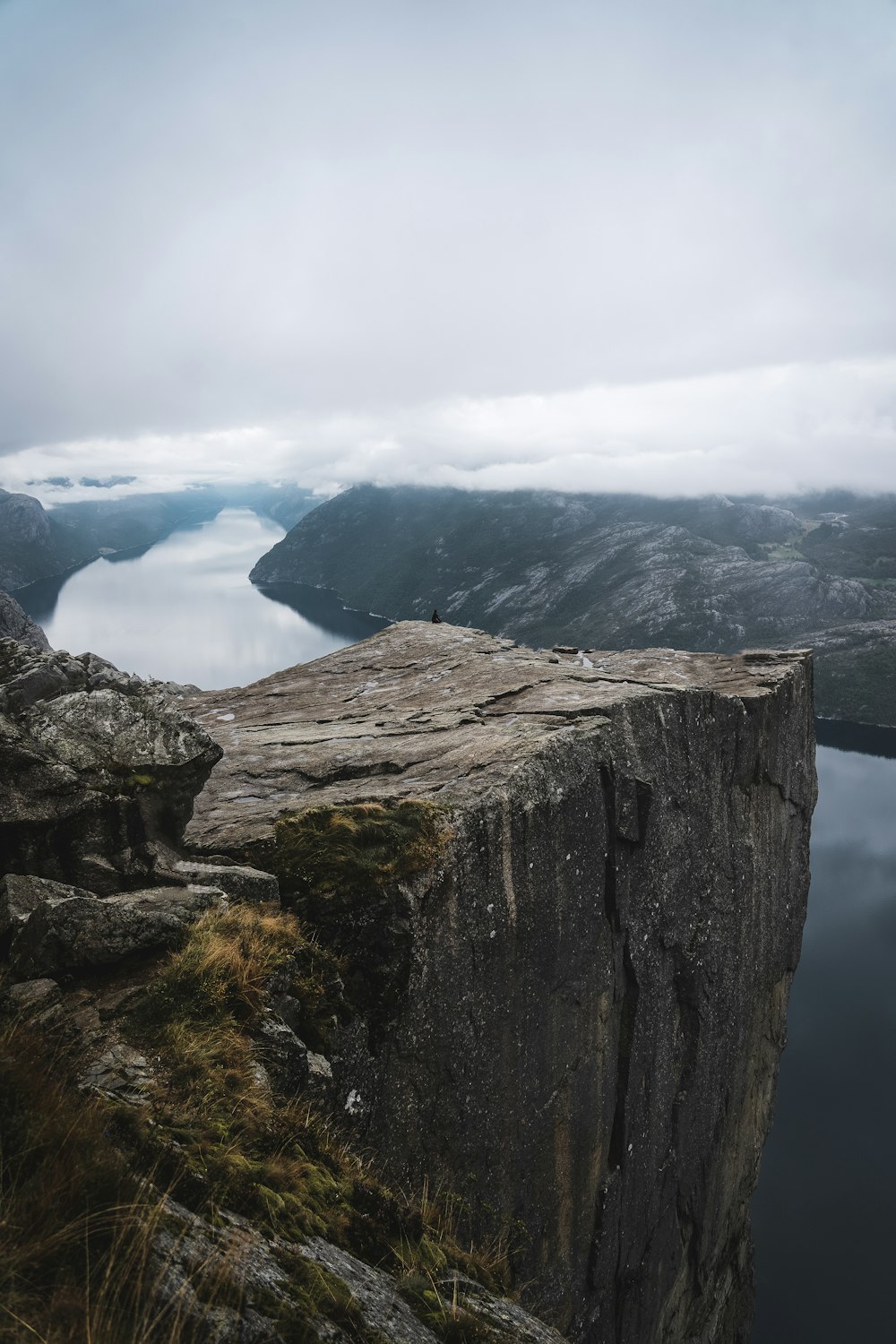 a cliff with a body of water below