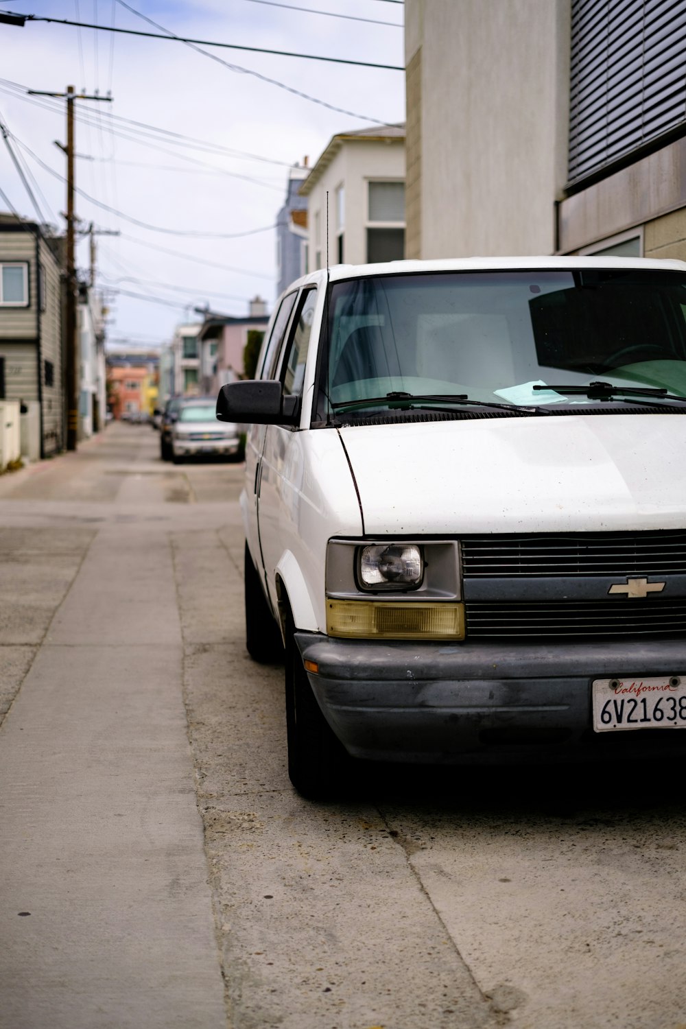 a white car parked on the side of a street