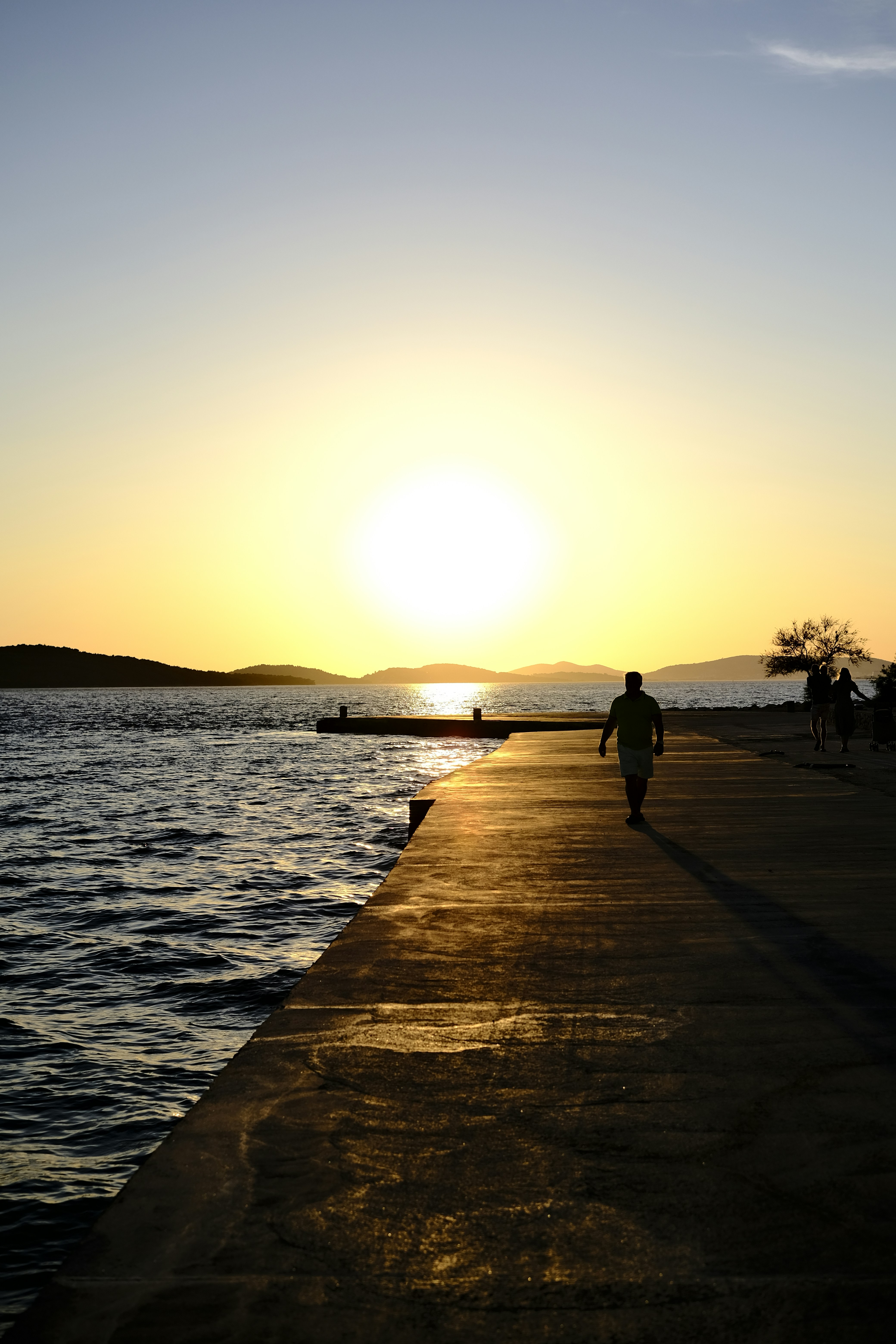 a group of people walking on a beach