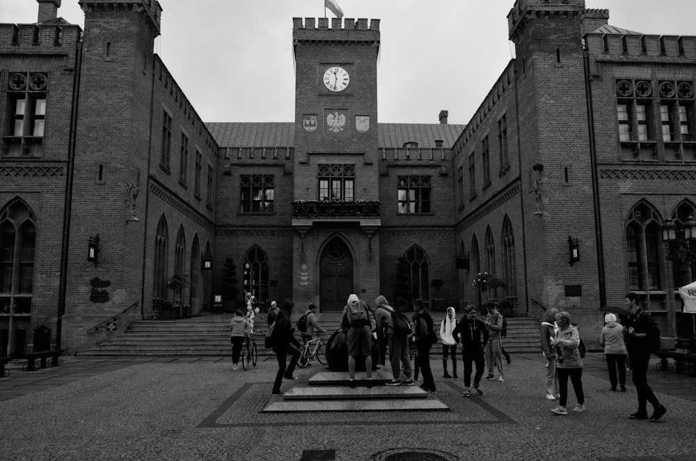 a group of people walking in front of a building