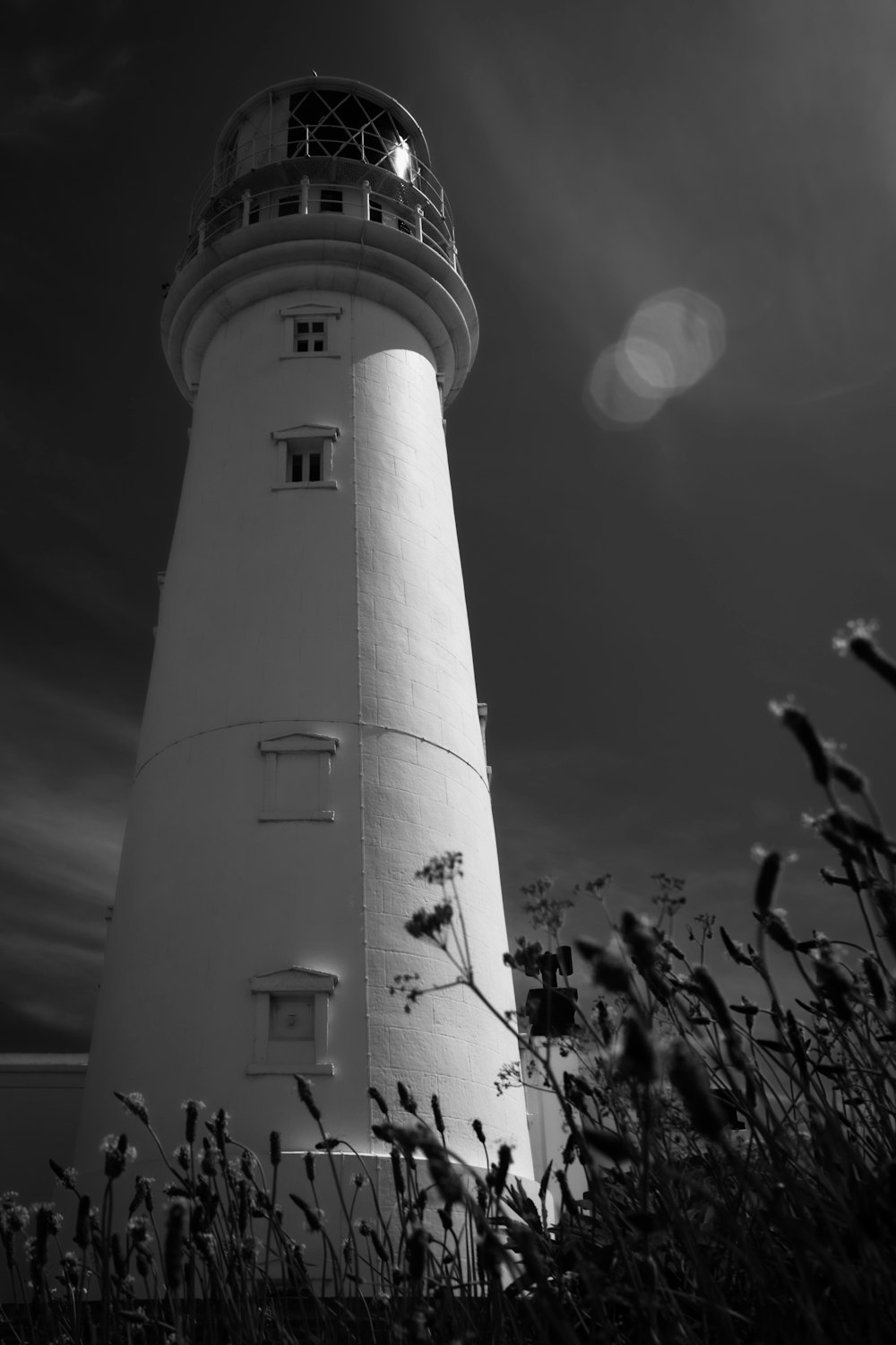 a white tower with a light on top