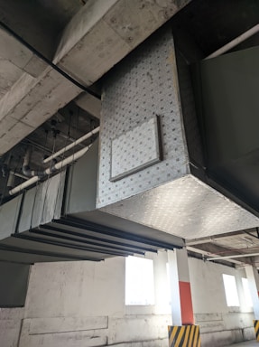 Industrial ventilation system installation in progress inside a large warehouse