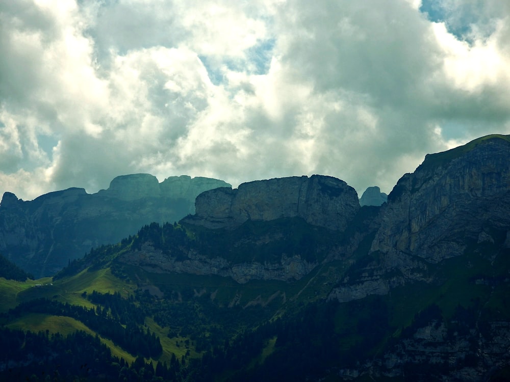 a mountain range with clouds