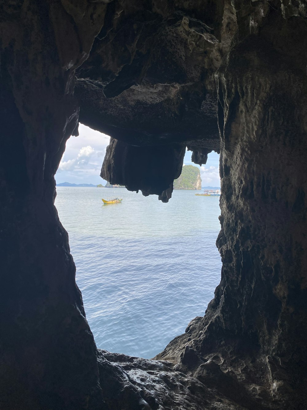 a view of the ocean through a cave