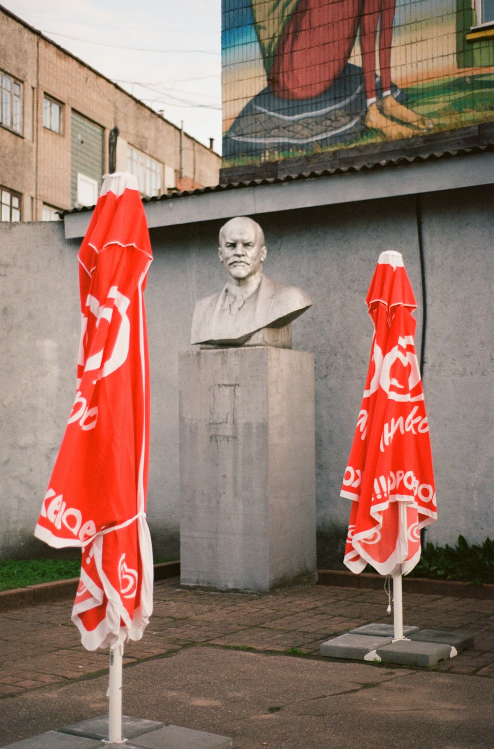 a statue of a person with a flag in front of it