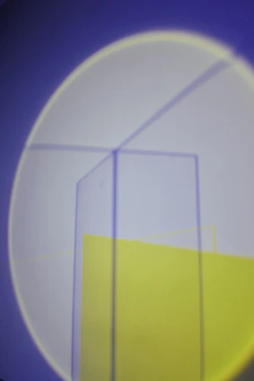 Abstract geometric shapes symbolizing upward motion and light breaking through a horizon.