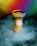 A colorful hookah bowl is surrounded by thick, swirling smoke, creating a mystical atmosphere. The background features an intense gradient of vibrant colors, including yellow, red, green, and blue.