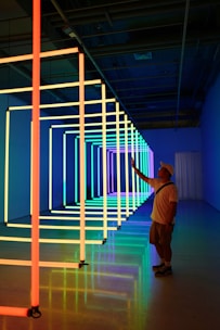 A student practicing neon flex bending in a bright workshop.