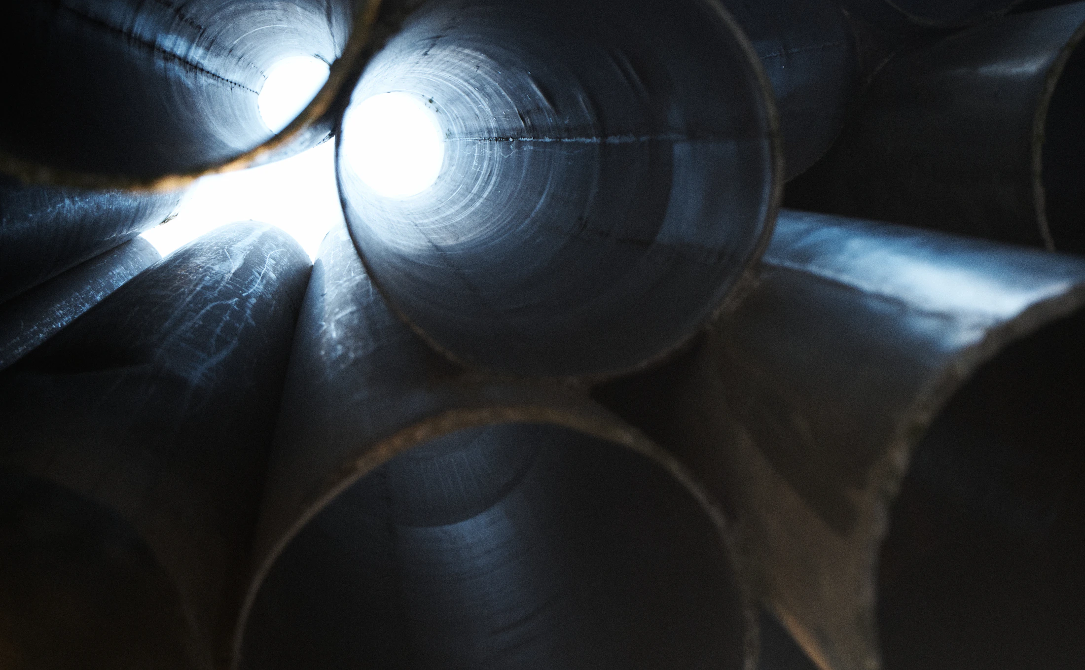 Large-diameter steel pipe section with hollow interior and metal wall visible