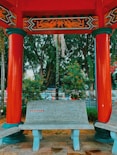 a bench under a red awning