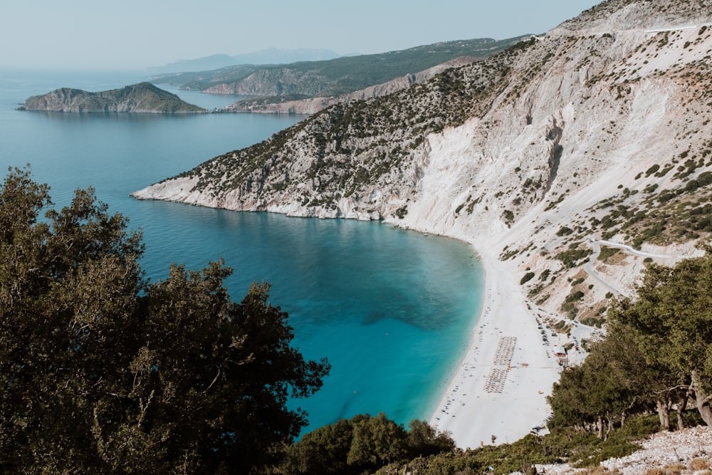 a beach with a body of water by it with Myrtos Beach in the background