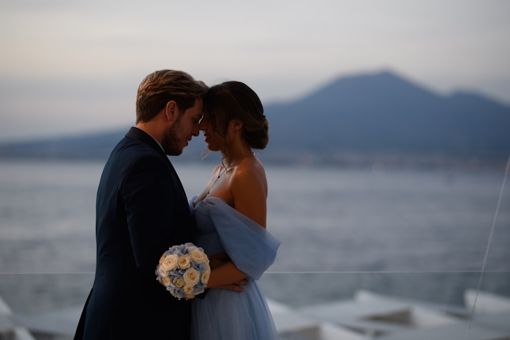 a man and woman kissing on a boat