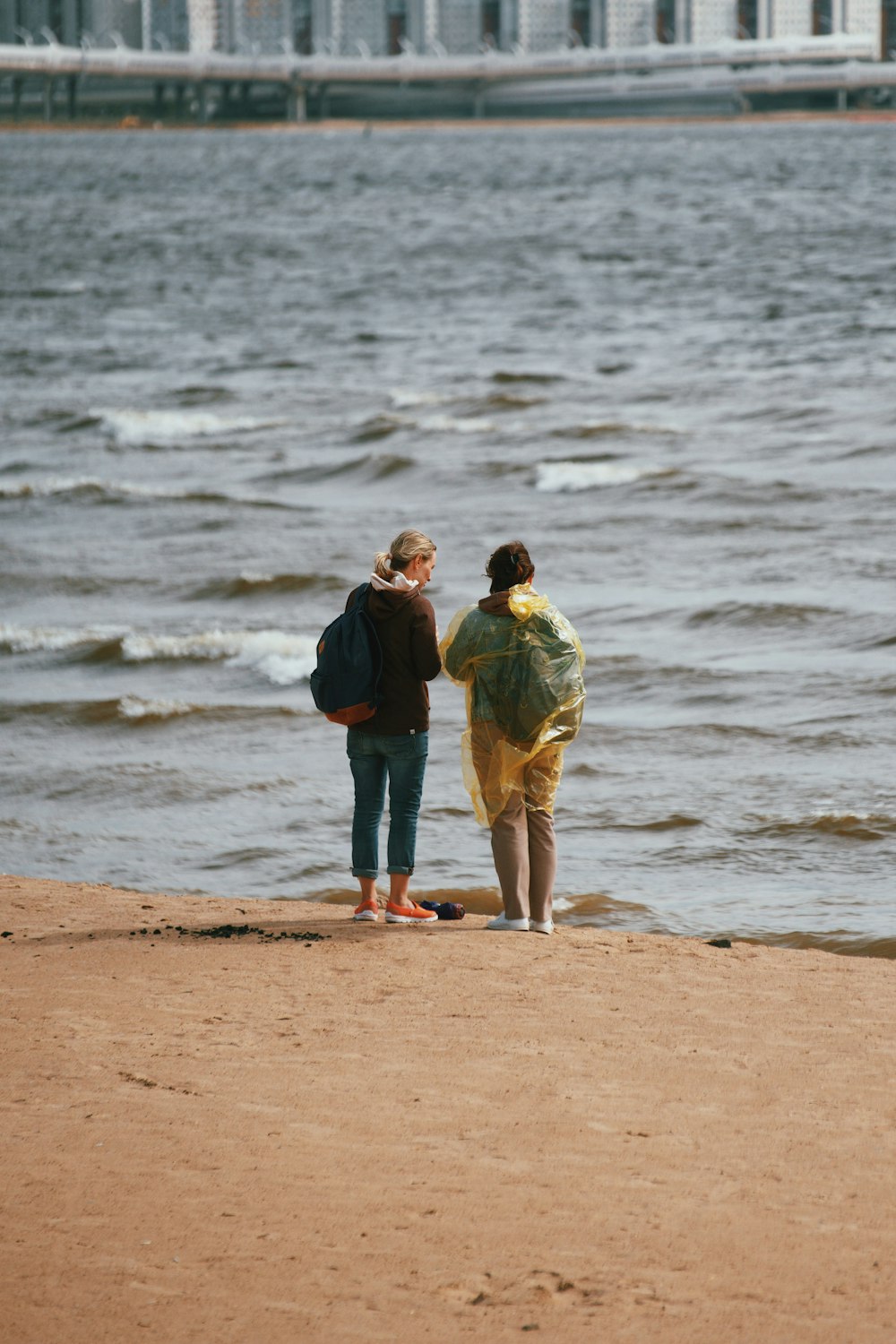 a man and woman standing on a beach