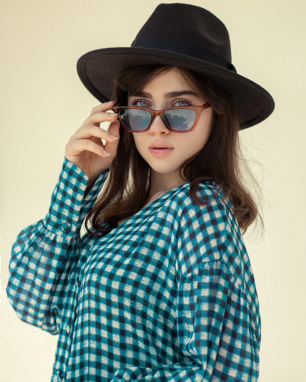 a person wearing a hat and sunglasses