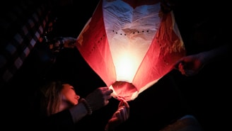 a man holding a red and white flag